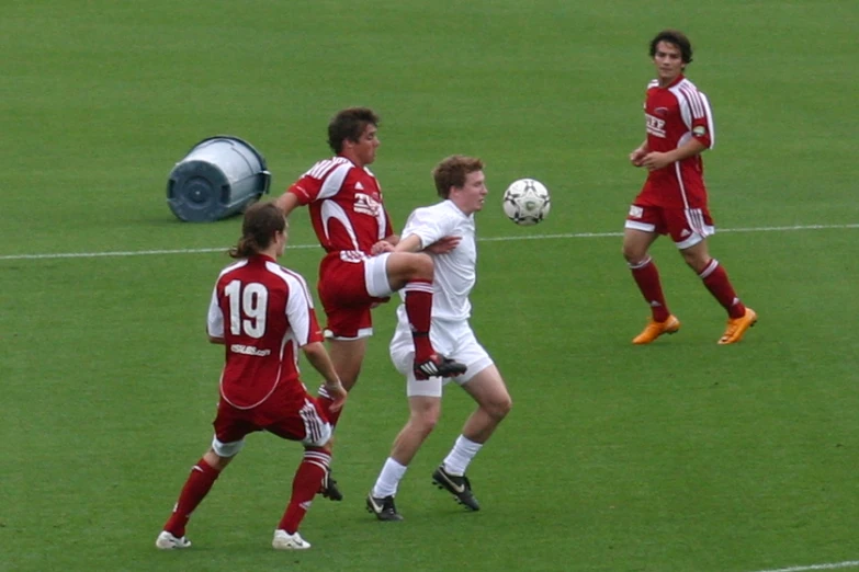 the group of young men are playing soccer on a field