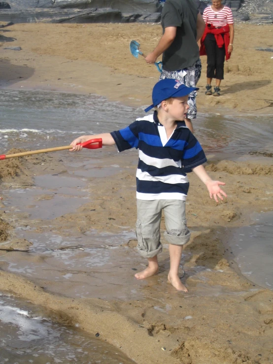 a child on the beach playing in the mud