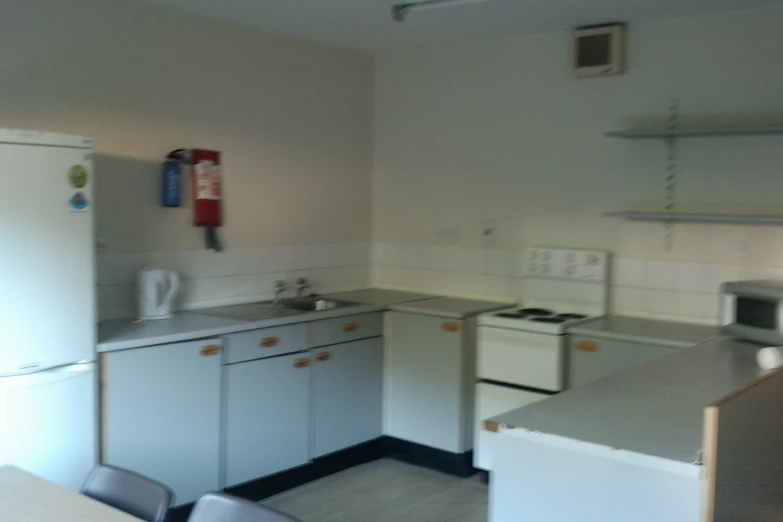 this is a small kitchen with white appliances