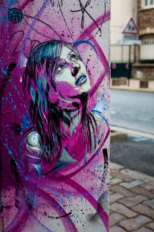 graffiti on a column with a woman's head painted on it