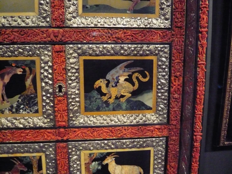 a cabinet with pictures on it, on the floor