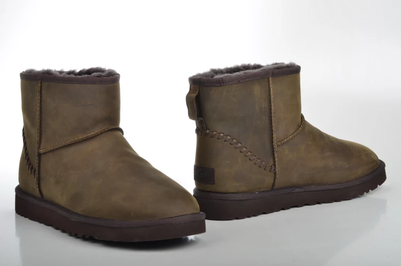a pair of brown boot shoes with two side ons on the back