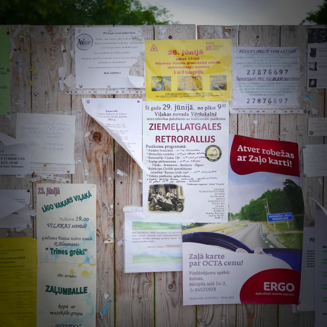 a bunch of paper that is on a fence