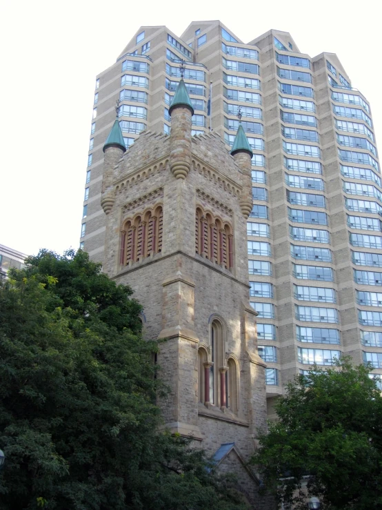 the building has a clock on one side and two towers