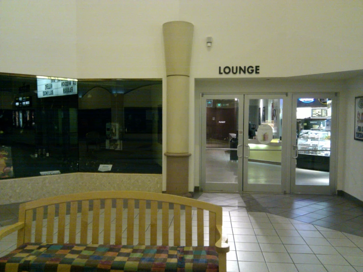 large lobby with white and tan tile floors and a lounge area