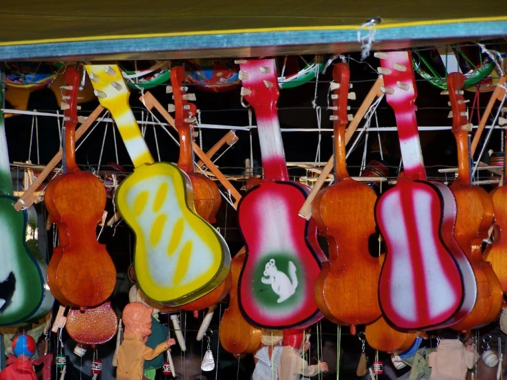 guitars hang from the ceiling at an outdoor market
