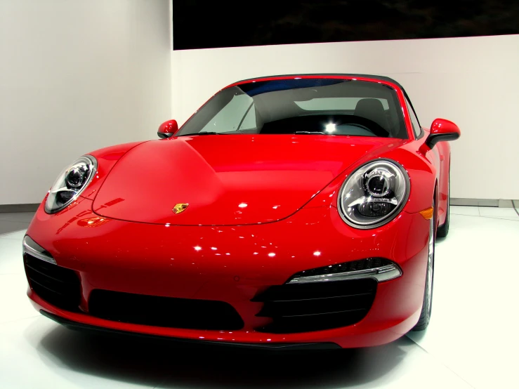 a close up of a red sports car on display