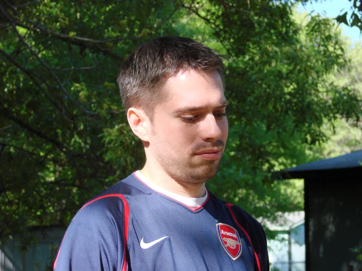 a close up of a man wearing a soccer uniform