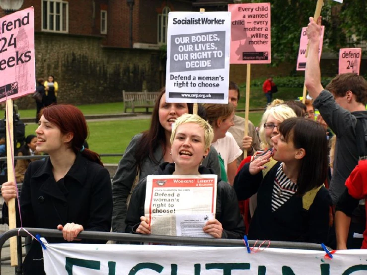 protesters hold signs and hold signs during a protest