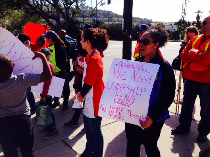 protestors hold signs on a city street