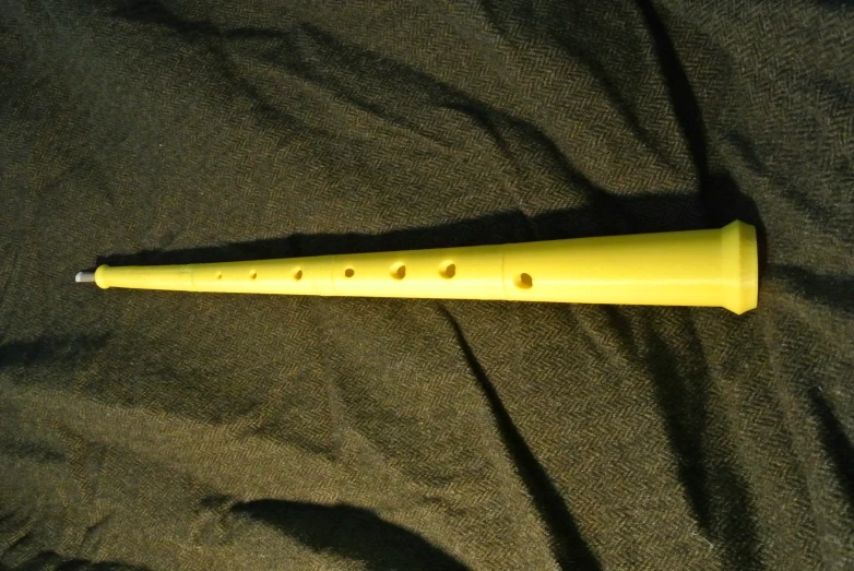 the yellow rubber toy has two holes in it