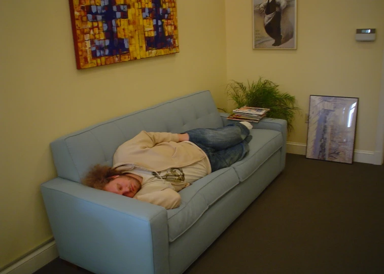 an image of a girl that is laying on a couch