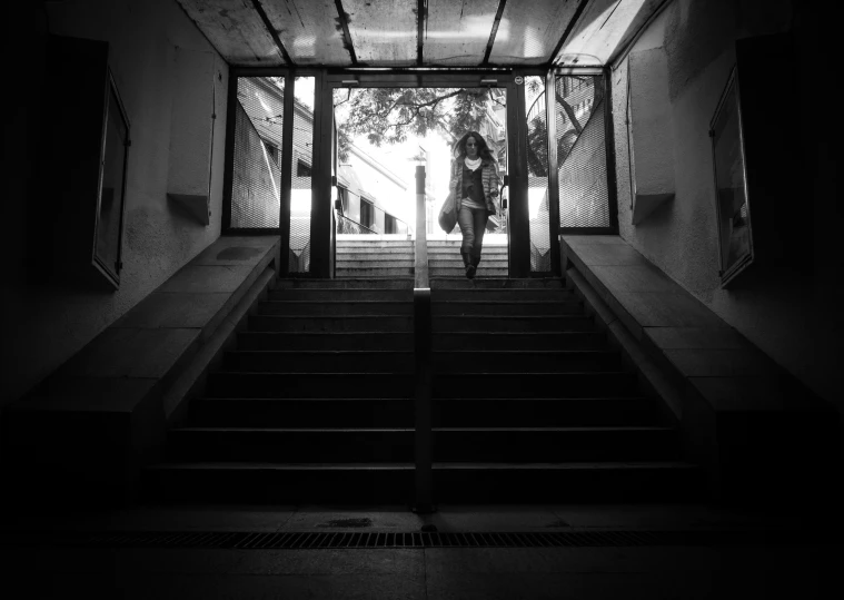 two people walking down stairs that are lit up