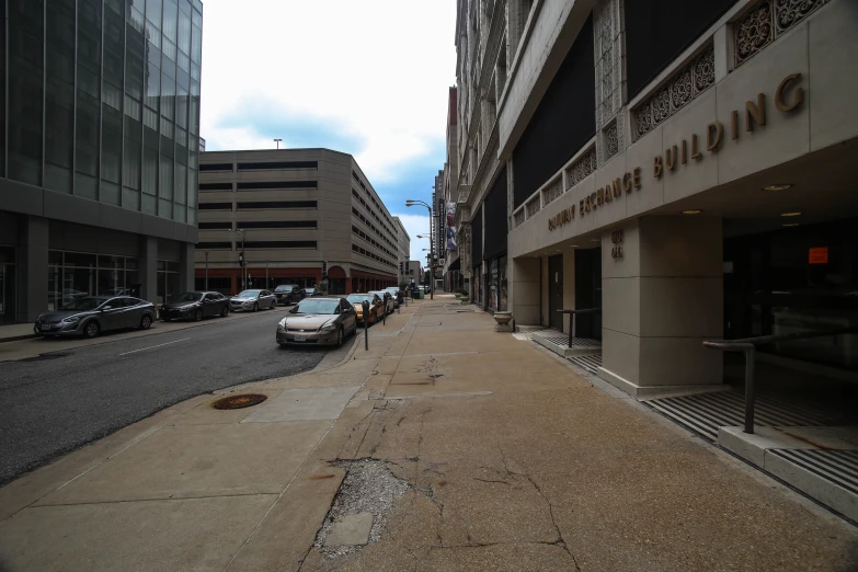 a street view of parking in front of office buildings