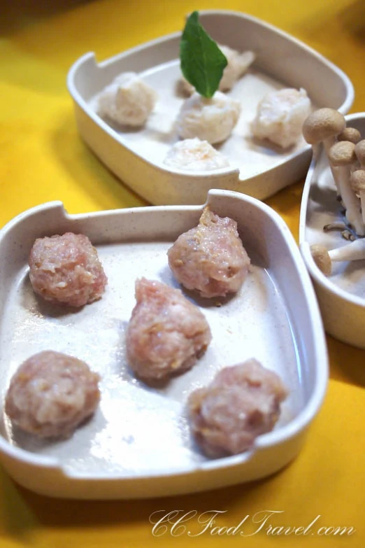 three containers of different sized food with mushrooms in the bottom