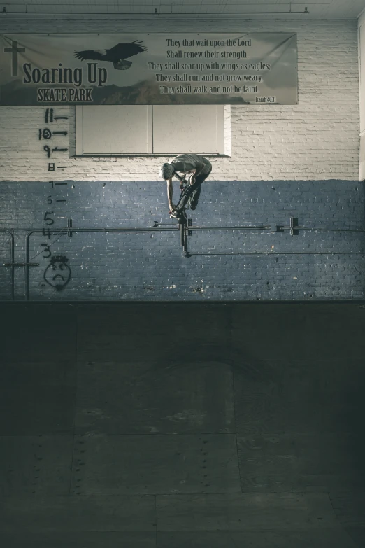 a bicycle rider on a rail near a building