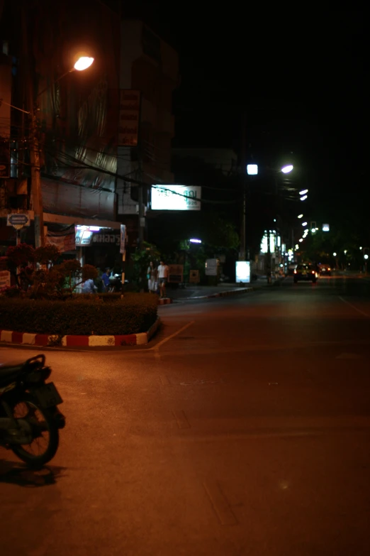 there is a motorcycle parked at the side of the street