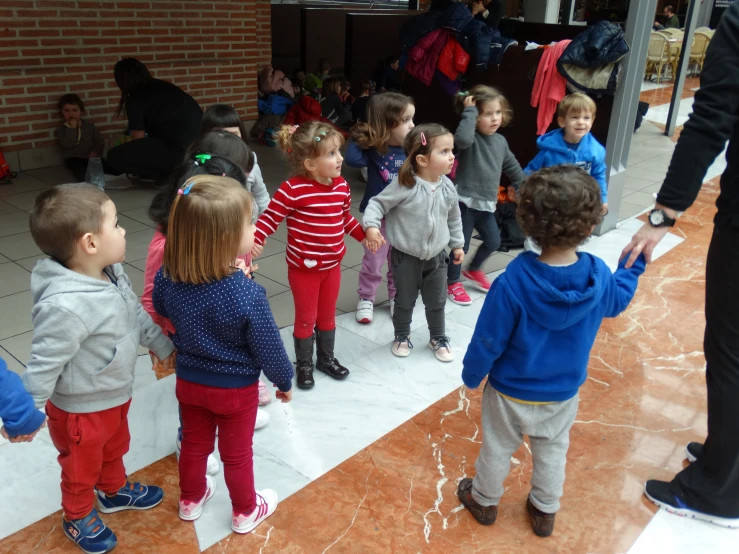 small group of children holding hands in outdoor area