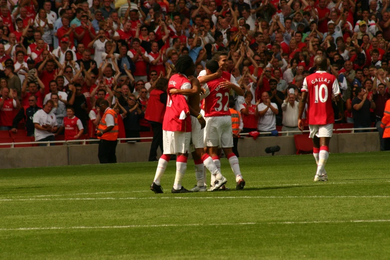 three men wearing red and white uniforms celeting during a game