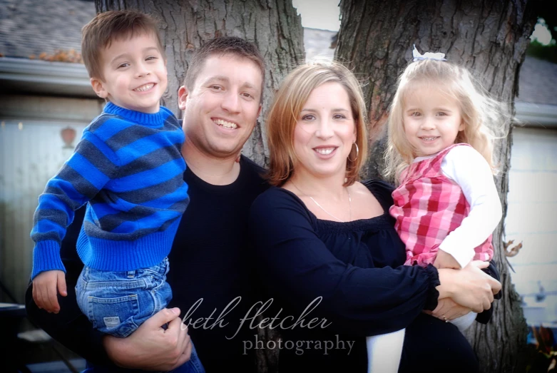 three people posing for a family po