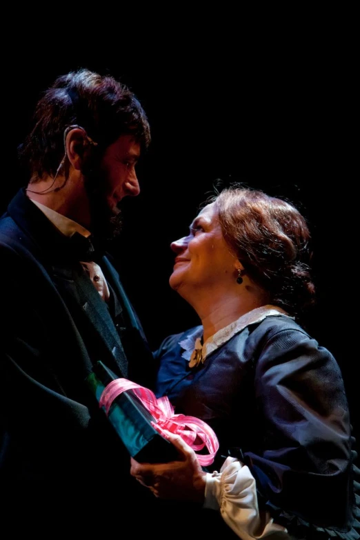 a man and a woman dance with each other on stage