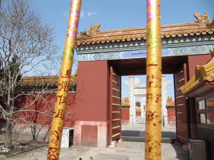 an ornate archway to another building with intricate gold trim