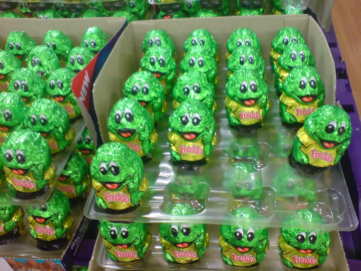 a display case with green spritet skulls and sprinkled chocolate eggs