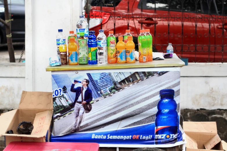 the table is covered with bottles of water and fruit