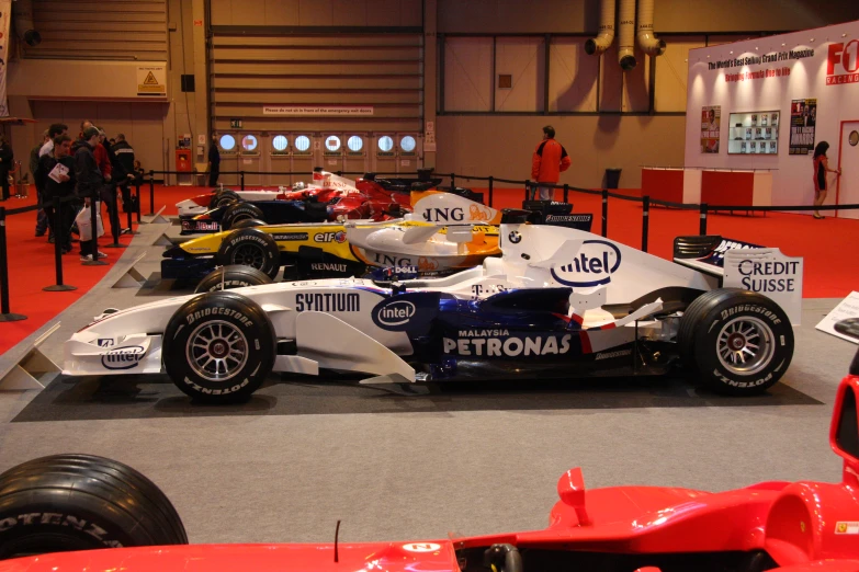 the racing car is parked in the showroom