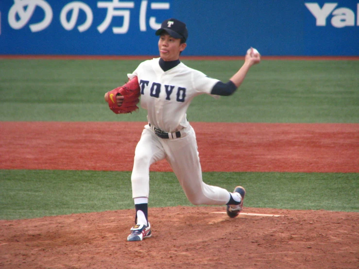 a baseball player throwing a ball on top of a field