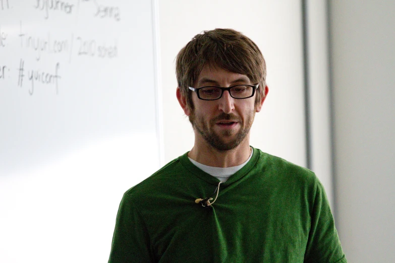 a man standing in front of a whiteboard