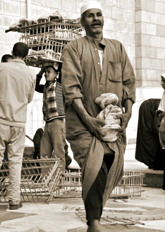 an old man walking while holding a basket