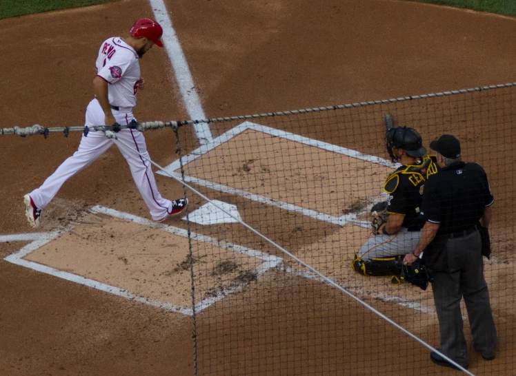 the baseball player is swinging at a pitch