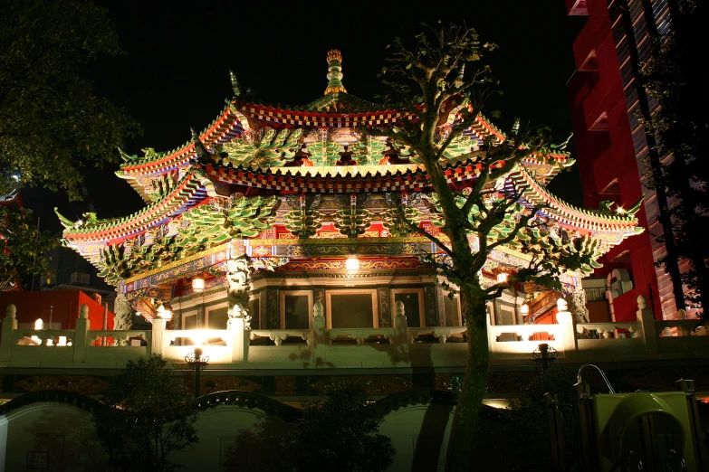 a lighted pagoda on the side of a road