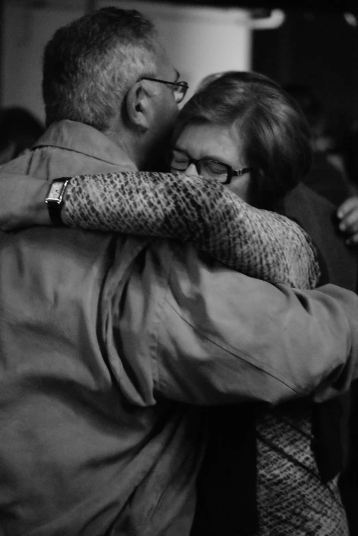 black and white po of man hugging a woman