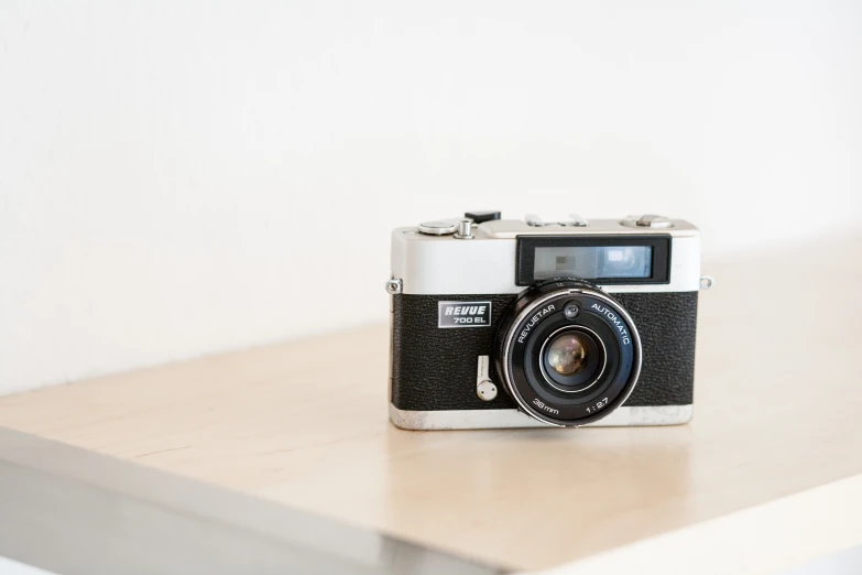 a camera sitting on top of a wooden table