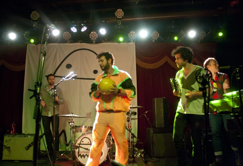 a group of people are on stage with musical instruments