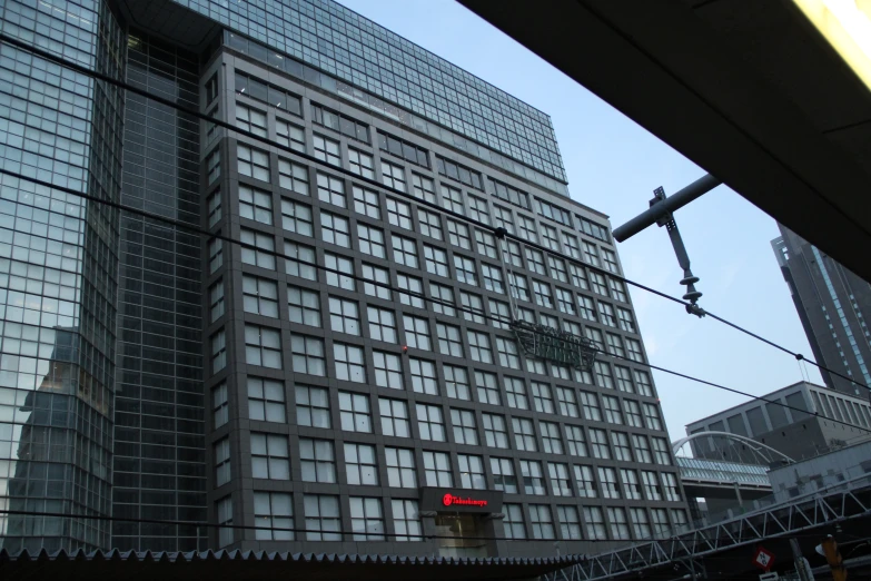 large glass buildings with many windows and a sign saying the letter s
