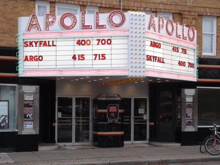 this is a theater on the corner with people