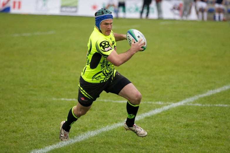 a man in the middle of a rugby game
