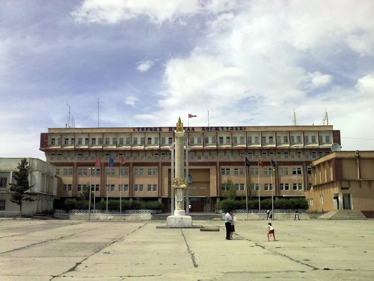 two people standing in front of the building