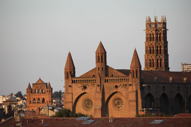 cathedral type building with three spires towering above rooftops