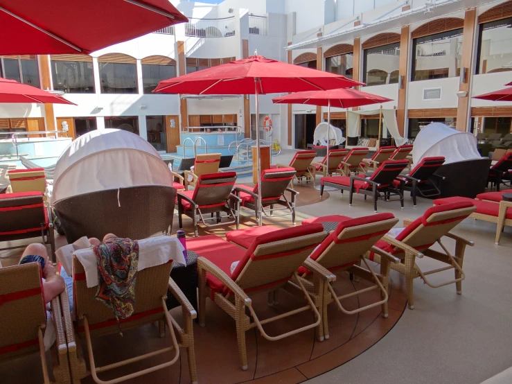 beach chairs covered in covers with people swimming and sitting on the beach