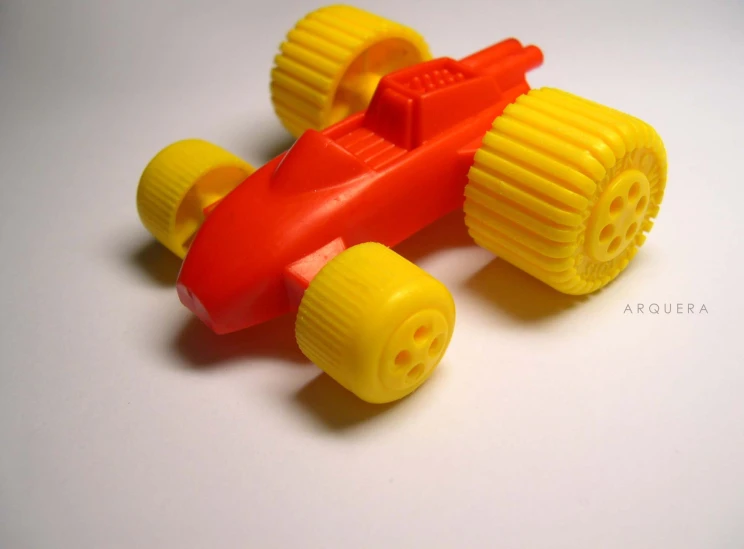 an orange toy car with a yellow body