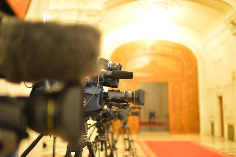 cameras are parked in a long line on the floor