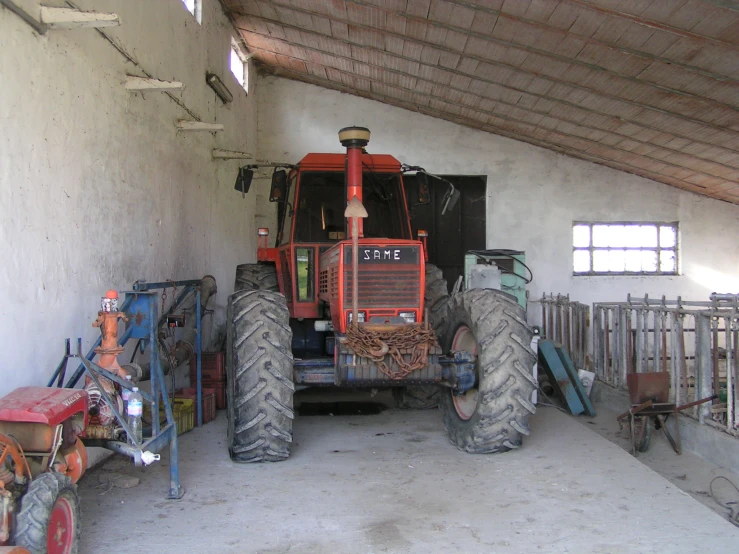the front of the tractor is out in its barn