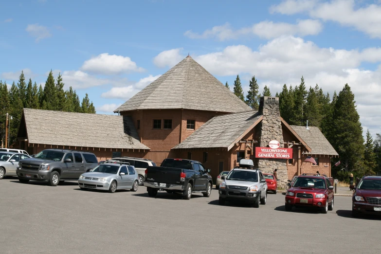 a group of cars parked outside a business in a parking lot