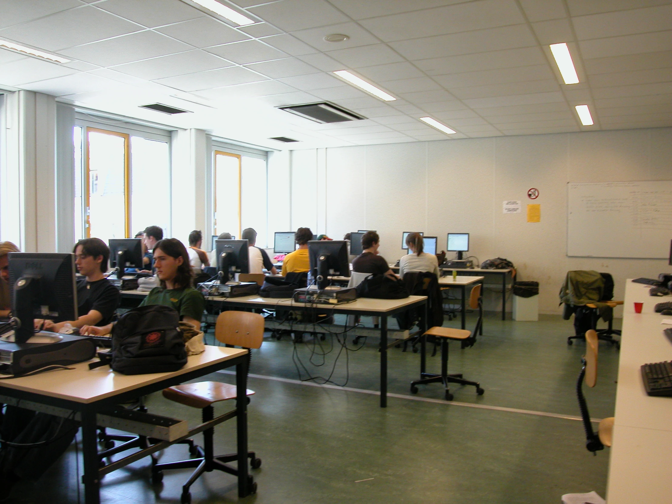 a group of people using their computer in a room