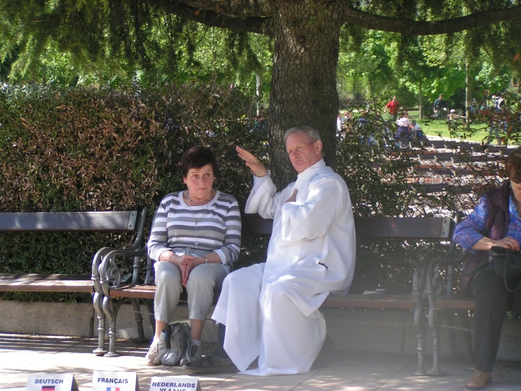 a priest and a woman are sitting on the bench