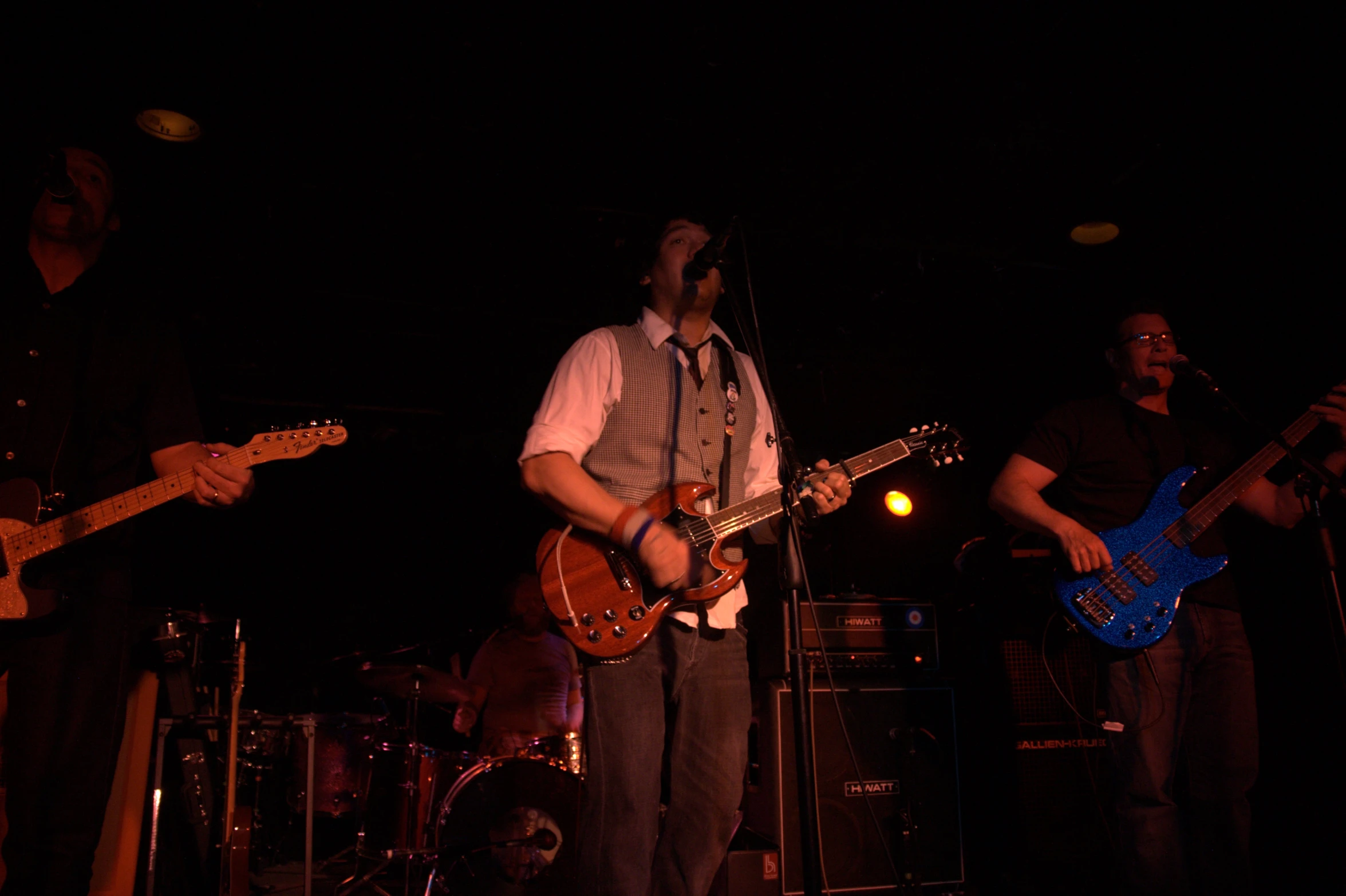 two men on stage playing guitars and an on guitar